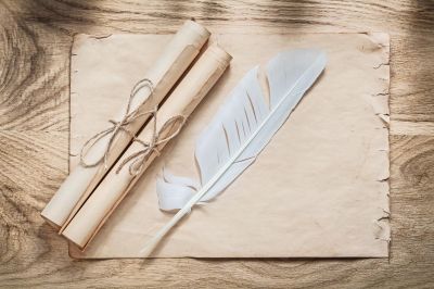 medieval-parchment-paper-scrolls-feather-wooden-board_275559-1399.jpg