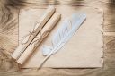 medieval-parchment-paper-scrolls-feather-wooden-board_275559-1399.jpg