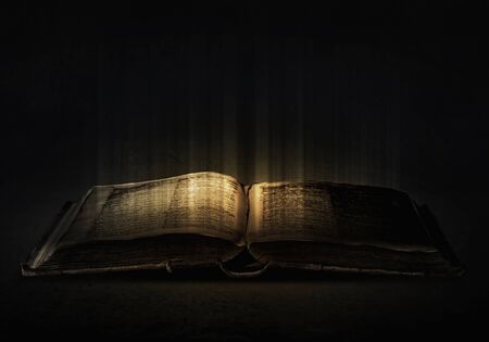 44983044-old-black-magic-book-with-lights-on-pages.jpg