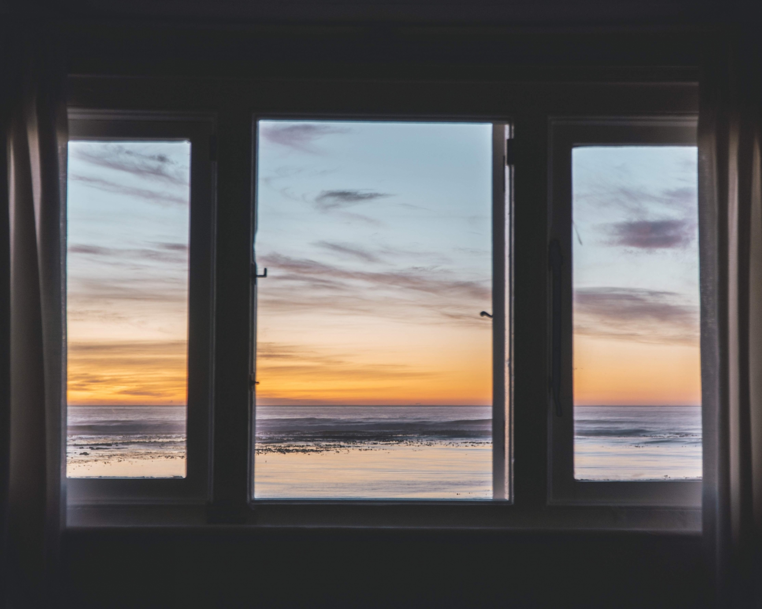 three-paneled-window-with-beautiful-view-sunset-outside.jpg