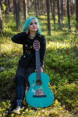 a-musician-with-blue-hair-and-a-blue-guitar-resting-in-the-park-outdoor-beautiful-music-musician-girl_t20_pRnQvj~8.jpg