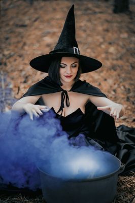 black-witch-sits-in-front-of-cauldron-from-which-violet-smoke-is-falling-sorceress-conjures-brews_t20_eVvZbL~8.jpg