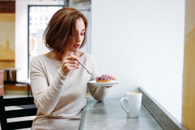 charming-brunette-woman-sitting-at-window-eating-dessert-in-cafe_t20_RzOoLk~8.jpg