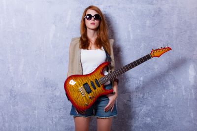 redhead-girl-with-guitar-near-wall-2022-01-13-21-16-52-utc~2.jpg