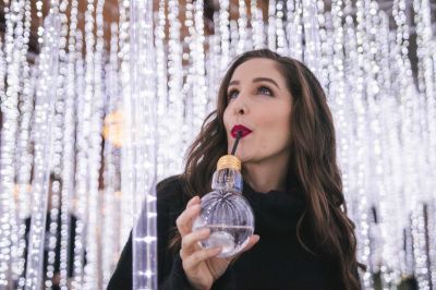 woman-enjoying-a-festive-drink-while-marvelling-at-a-magical-christmas-light-display_t20_GJZZgw~8.jpg