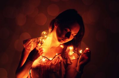 woman-holding-christmas-lights-around-her-neck-and-dreaming_t20_JaK7al~8.jpg