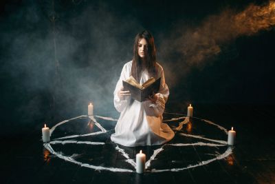 woman-sitting-in-the-center-of-pentagram-circle-PEAW8S6~8.jpg