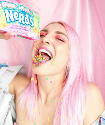 woman-with-pink-hair-pouring-nerds-candy-in-her-mouth-2156656~8.jpg