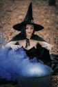 black-witch-sits-in-front-of-cauldron-from-which-violet-smoke-is-falling-sorceress-conjures-brews_t20_eVvZbL~8.jpg