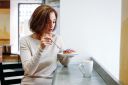 charming-brunette-woman-sitting-at-window-eating-dessert-in-cafe_t20_RzOoLk~8.jpg